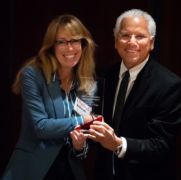 Debbie Clegg, PhD, associate dean of research at CNHP receiving an award from Richard DiMarchi, PhD, the Standiford H. Cox Distinguished Professor of Chemistry at Indiana University